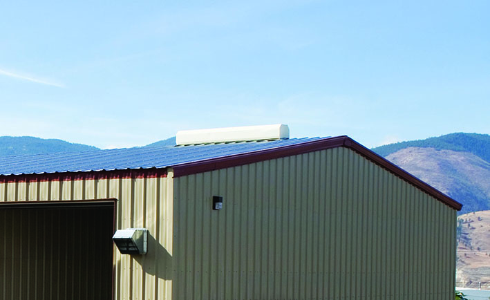 Steel building with white ridge vent on PBR roof