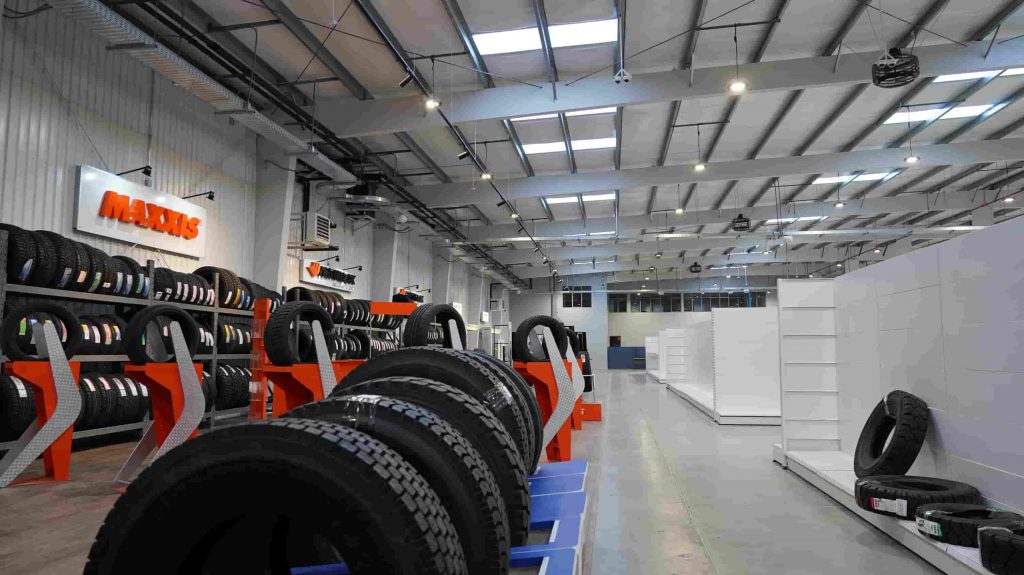 Steel building warehouse and showroom with tire racks for storage and display