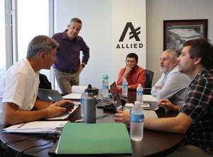 Team of engineers and clients reviewing a steel building design.