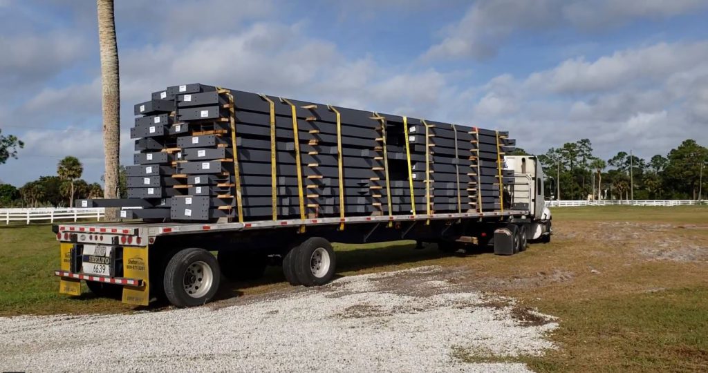 Steel building components being transported on flatbed truck