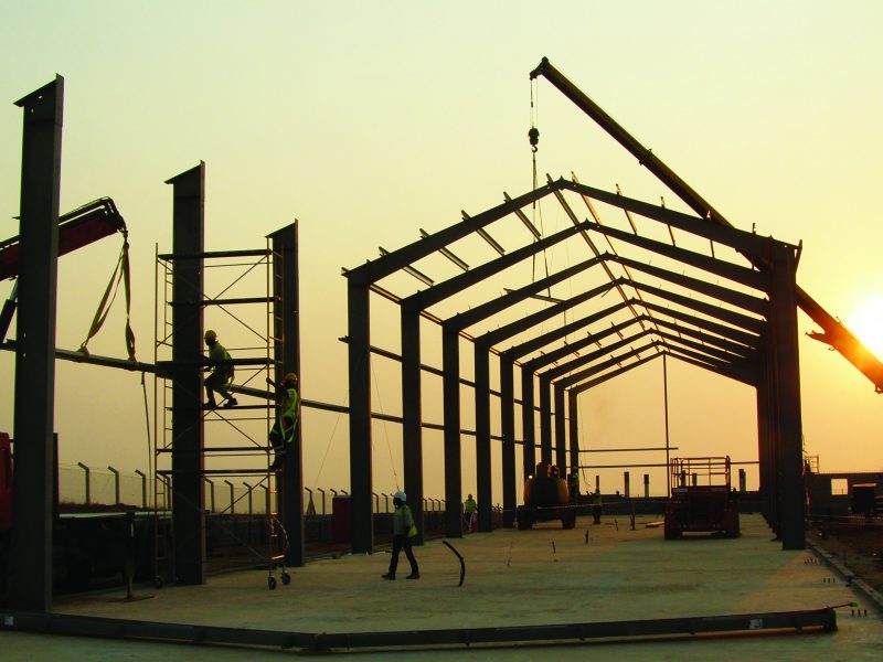 Allied Steel employees on jobsite building steel commercial canopy in Angola