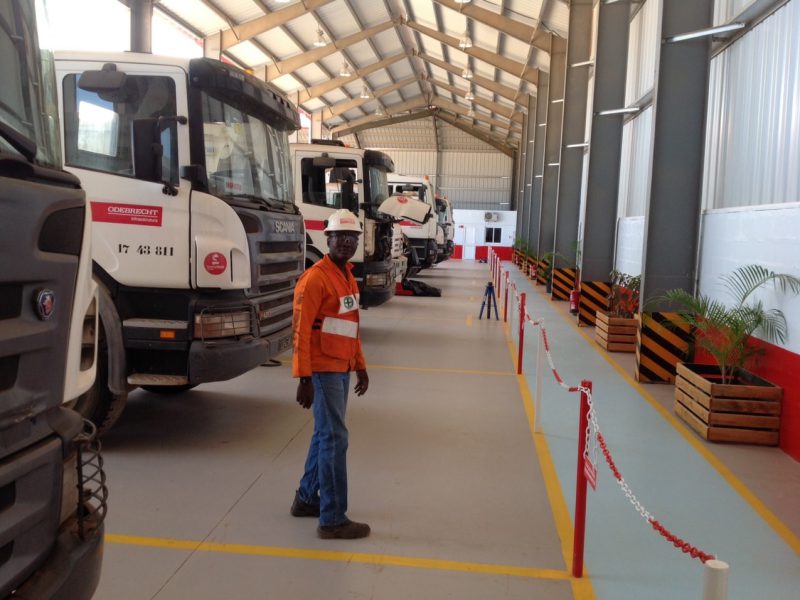 A worker at an industrial canopy steel building in Angola