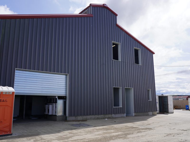 Seafood processing facility with walk door, overhead door