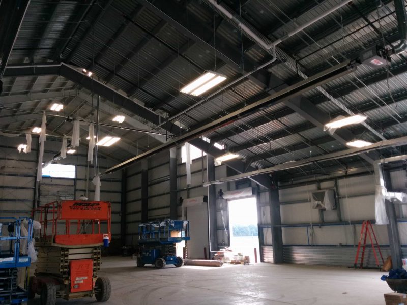 Interior of a industrial hangar with clearspan framing, skylights and overhead doors