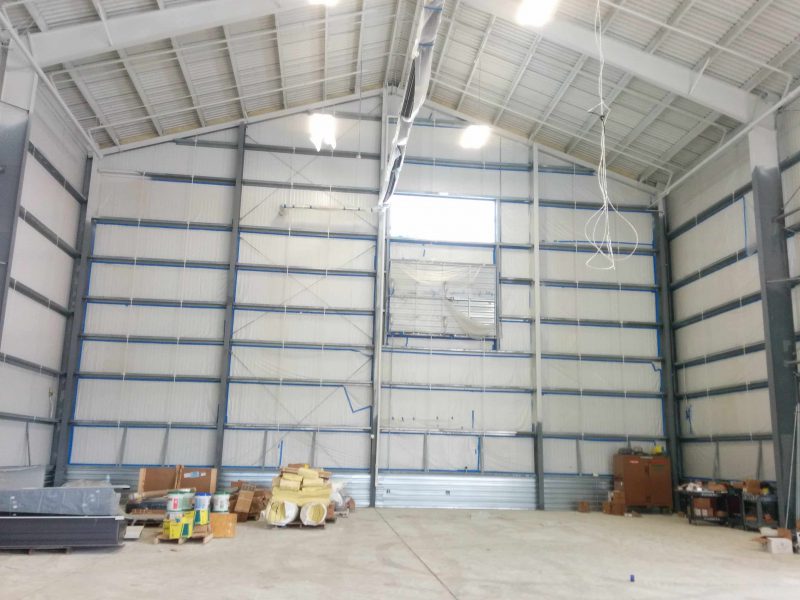 Interior of a steel industrial hangar with clear span framing