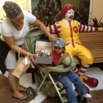 Mom with little guest looking at a pair of shoes at Ronald McDonald House Fort Lauderdale