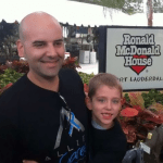 Allied President Michael Lassner with a kid at a Ronald McDonald House outreach in Fort Lauderdale