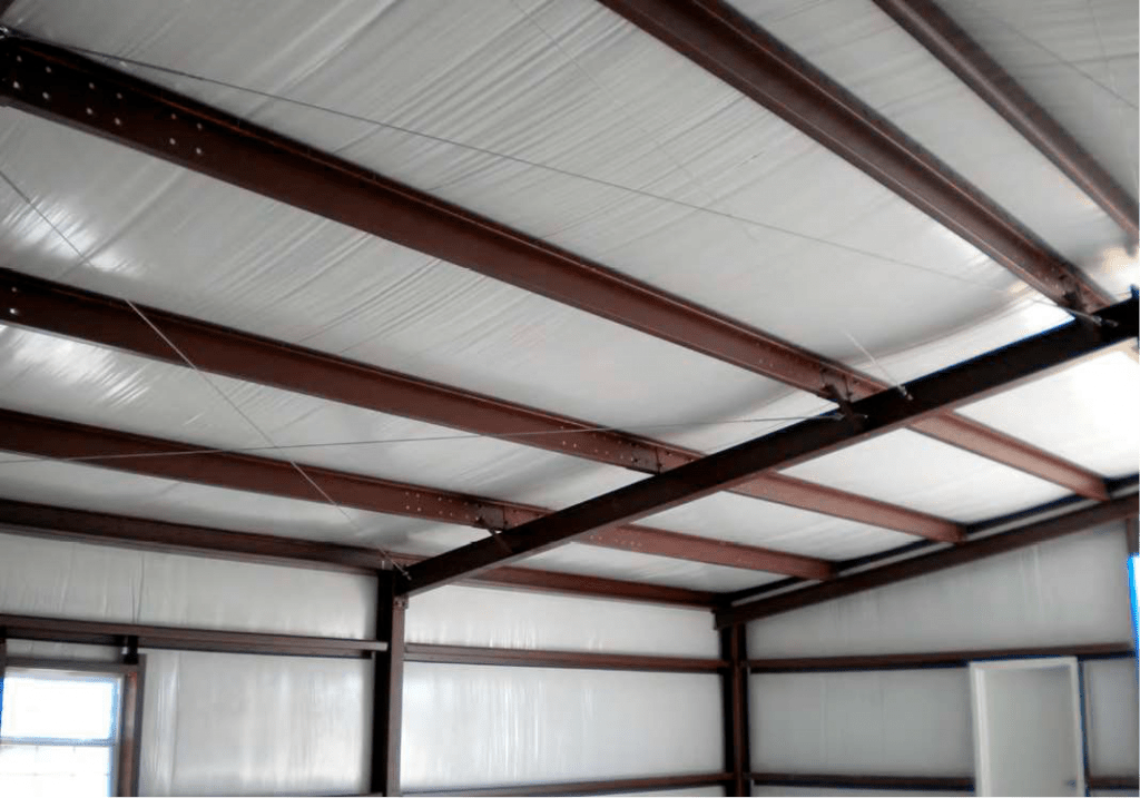 Steel building with vinyl backed fiberglass insulation