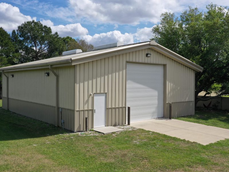 40x50x12 Tan gable steel building garage kit with wainscott, walk door, and overhead door.