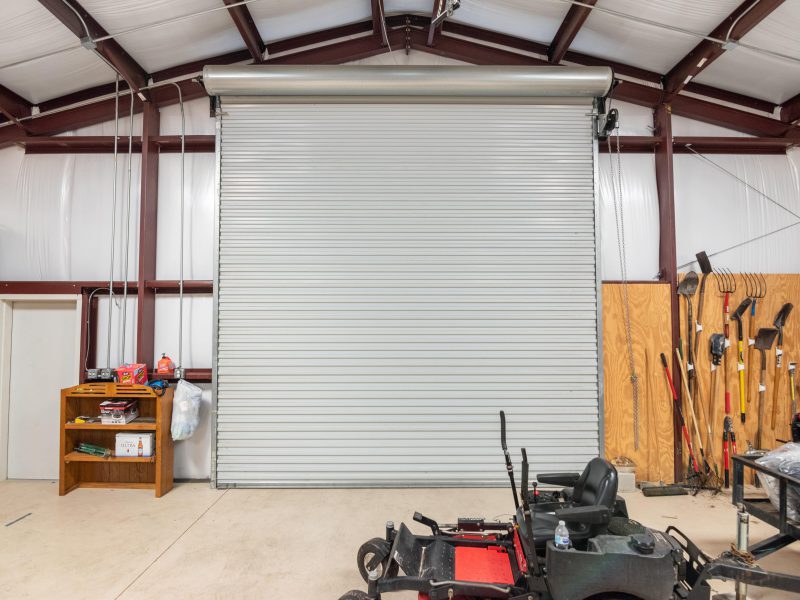 40x50x12 Tan gable steel building garage kit with wainscott, walk door, and overhead door.