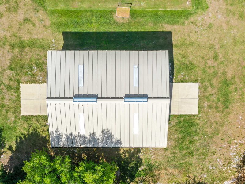 40x50x12 Tan gable steel building garage kit with wainscott, walk door, and overhead door.