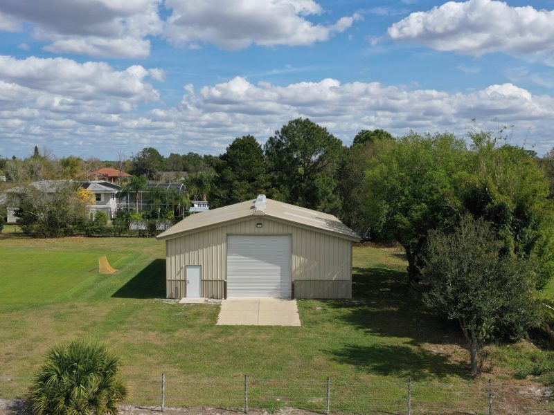 40x50x12 Tan gable steel building garage kit with wainscott, walk door, and overhead door.